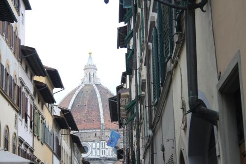 a view of a cathedral from a street with buildings at Accademia Studio in Florence