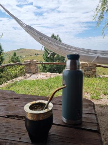 a bottle of water sitting on a table with a spoon at Estancia Altos del Durazno in Estancia Grande
