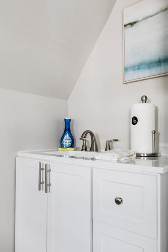 a white cabinet with a sink in a kitchen at G7 central location museums free parking in Richmond