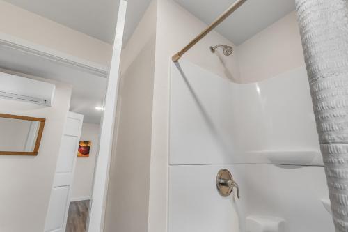 a bathroom with white walls and a shower at Prosecco by Simple Life Rentals in Fish Creek