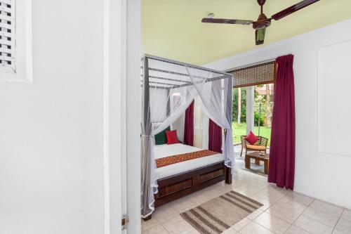 a bedroom with a bed with a canopy at AIDA Hotel - Bentota in Bentota