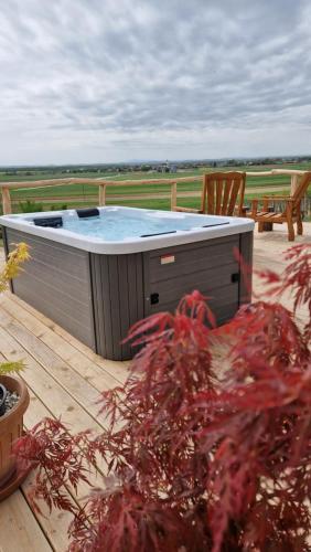 a hot tub sitting on top of a wooden deck at Holiday House Clavis in Dobrovnik