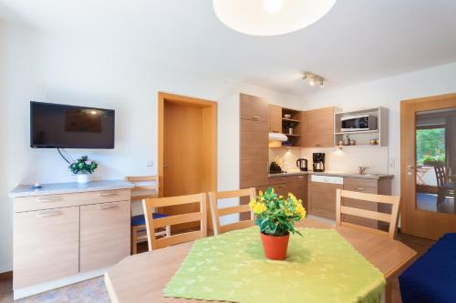 a kitchen and dining room with a table with a plant on it at Amtshaus in Tux