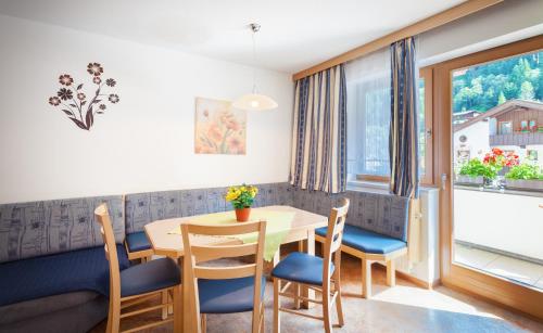 a dining room with a table and chairs at Amtshaus in Tux
