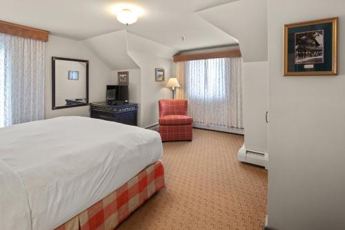 a hotel room with a bed and a chair at von Trapp Family Lodge & Resort in Stowe