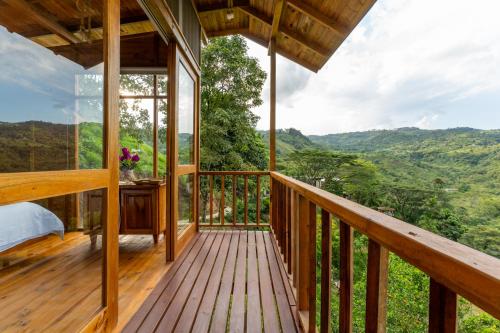 a room with a balcony with a view of the mountains at Home Boutique Natural Paradise in La Vega