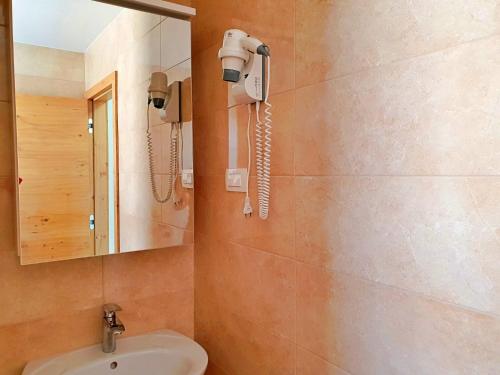 a bathroom with a sink and a phone on the wall at Villa Branka in Šilo