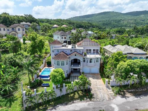an aerial view of a large white house with a pool at Mosaic luxury Villa in Hopewell