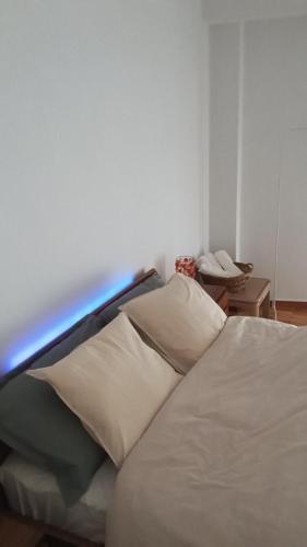 a white bed with a light on top of it at Mylos House in Tríkala