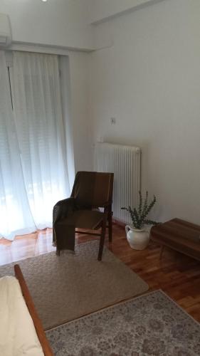 a living room with a chair and a table at Mylos House in Tríkala