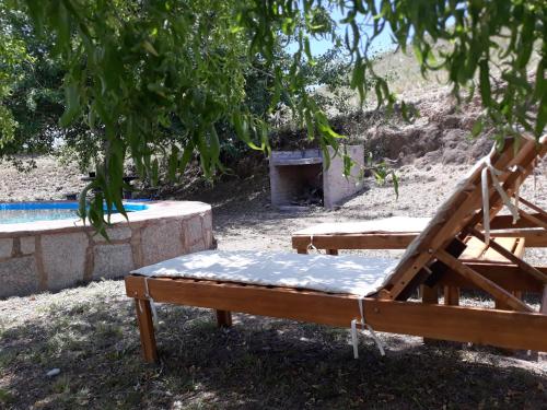 a couple of beds sitting under a tree at Estancia Altos del Durazno in Estancia Grande