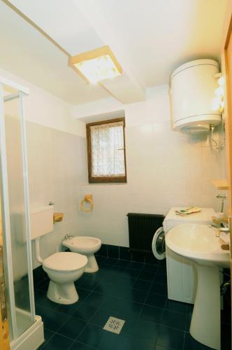 a bathroom with two toilets and a sink at CASA MOLINI Malé in Malè