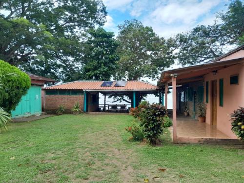 a view of a house with a yard at Hostel Los Chocoyos in Ometepe
