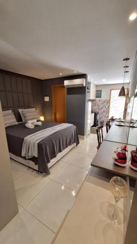 a bedroom with a bed and a dining room at Aconchegante stúdio com varanda in Bananeiras