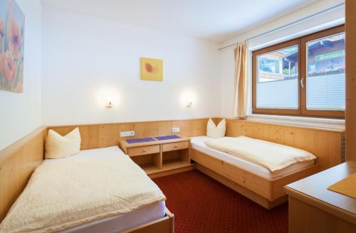 a small room with two beds and a window at Amtshaus in Tux
