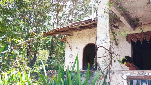 a person standing outside of a small building at Bela Oyá Casa Hostel in Vale do Capao