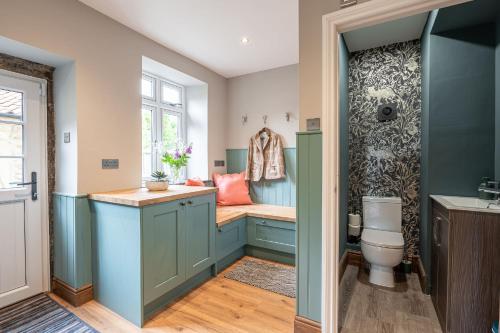 a bathroom with a toilet and a window at Fairfield House in Newsham