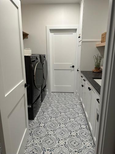 a kitchen with a washing machine and a white door at Vita Huset by Simple Life Rentals in Sister Bay
