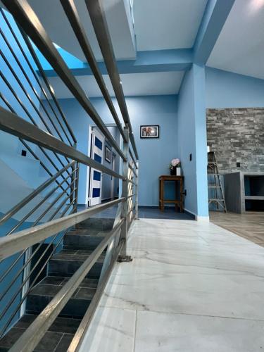 a staircase in a room with blue walls at Casa Cristina Mamá Regañona in Bahías de Huatulco