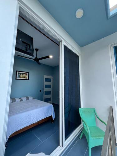 a bedroom with a bed and a large window at Casa Cristina Mamá Regañona in Bahías de Huatulco