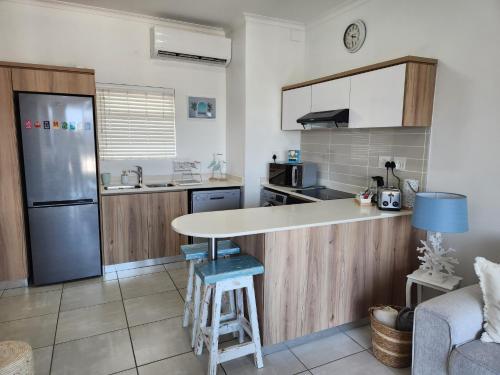 a kitchen with a counter and a refrigerator at Ballito Hills Modern Coastal Living in Ballito