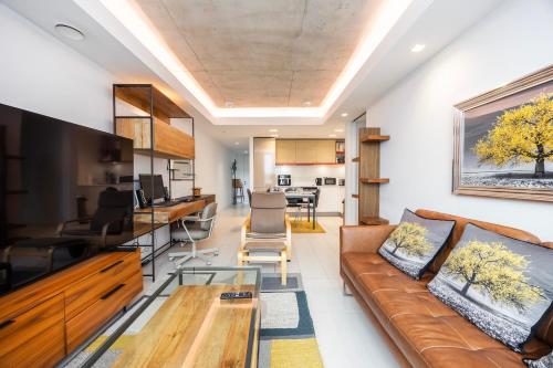 a living room with a couch and a table at Austin David Executive ExCeL in London