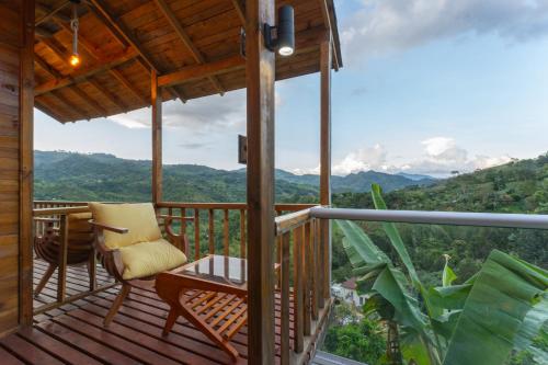 a balcony with a chair and a view of the mountains at Home Boutique Natural Paradise in La Vega