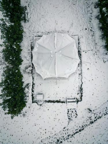 an overhead view of a white umbrella in the snow at Le Domaine de Bra in Bra
