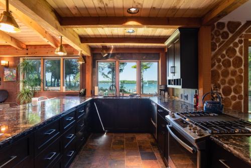 a kitchen with a stove and a counter top at Kangaroo East Shore by Simple Life Rentals in Baileys Harbor