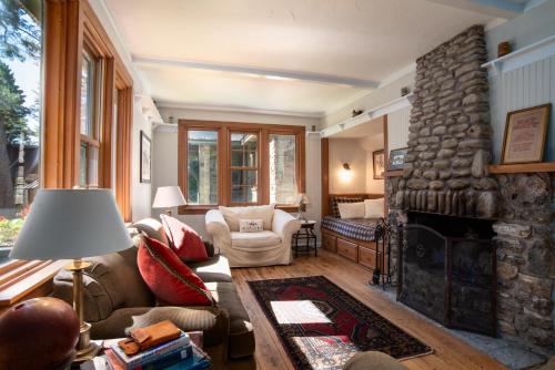 a living room with a couch and a stone fireplace at Kangaroo East Shore by Simple Life Rentals in Baileys Harbor