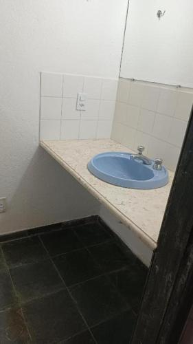 a bathroom with a blue sink in a room at Pouso do Elefante in Serra do Cipo