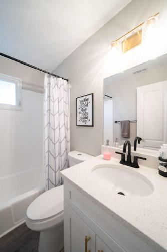 a white bathroom with a sink and a toilet at OV Mosaic - Sienna Suite in North Camellia Acres