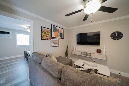 a living room with a couch and a ceiling fan at OV Mosaic - Topaz Suite in North Camellia Acres