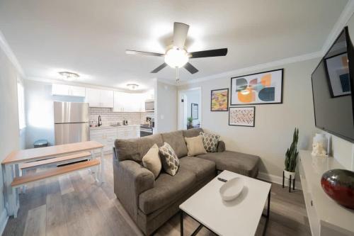 a living room with a couch and a table at OV Mosaic - Topaz Suite in North Camellia Acres