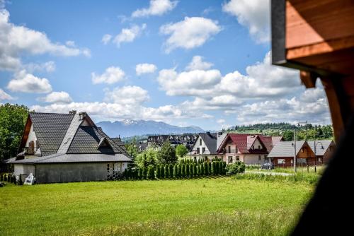 a view of a village with houses and a field at Cicha Woda 300 m od Gorący Potok i Termy Szaflary in Szaflary