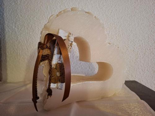 a white chair with a bow on a wall at Ferienwohnung zum Urfall -- Sommerbergbahnen inklusive !!! in Tannheim