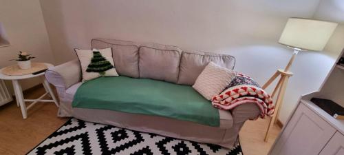 a couch with pillows on it in a living room at Casa in centrul Zalaului in Zalău