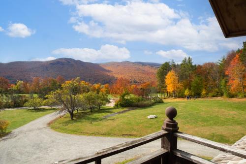 a view from the porch of a house with fall foliage at von Trapp Family Lodge & Resort in Stowe