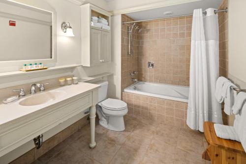 a bathroom with a sink and a toilet and a tub at von Trapp Family Lodge & Resort in Stowe