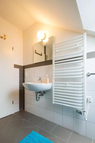 a bathroom with a sink and a mirror at Hotel Belle Etage in Düsseldorf
