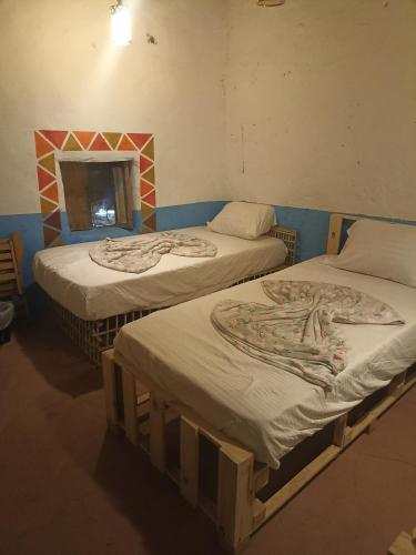 Postel nebo postele na pokoji v ubytování Bait Ward Nubian House