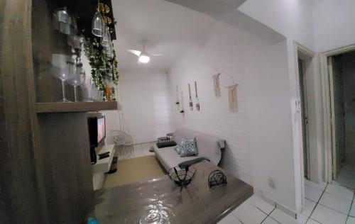 a living room with a couch and a tv at Apart511 in Santos
