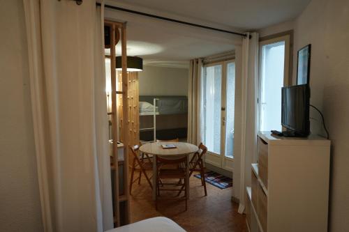 Cette chambre comprend une table et une télévision. dans l'établissement appartement 4 personnes, ascenseur, balcon, 100 m du télécabine, à Cauterets