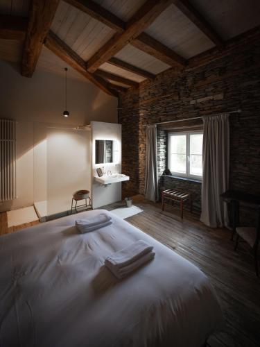 a bedroom with a large bed with towels on it at Château du Pont d'Oye in Habay-la-Neuve