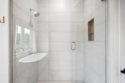 a white bathroom with a sink and a shower at Orchard View Retreat by Simple Life Rentals in Egg Harbor
