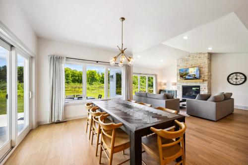 a dining room and living room with a table and chairs at Orchard View Retreat by Simple Life Rentals in Egg Harbor