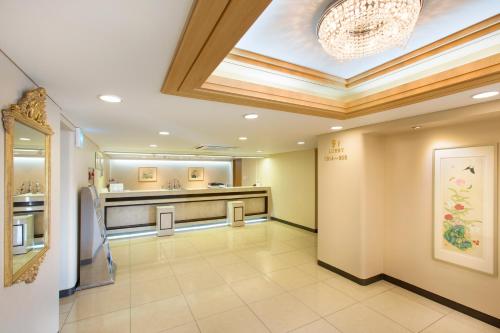 a lobby of a hospital with a chandelier at Libero Hotel in Busan