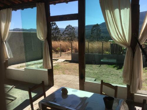 a room with a table and a window with a view at Pouso do Elefante in Serra do Cipo