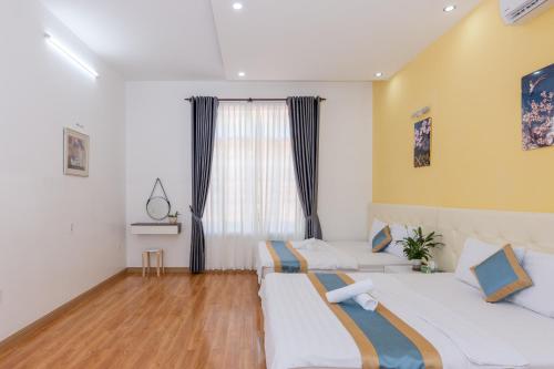 a bedroom with two beds and a window at Minh Phước Villa 12 Kim Ngân in Vung Tau