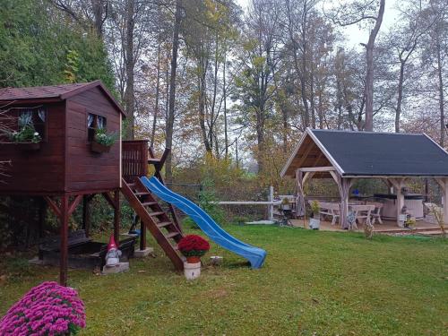a playground with a slide and a gazebo at Ustronne Chatki - Ostoja nad Potokiem in Ustroń